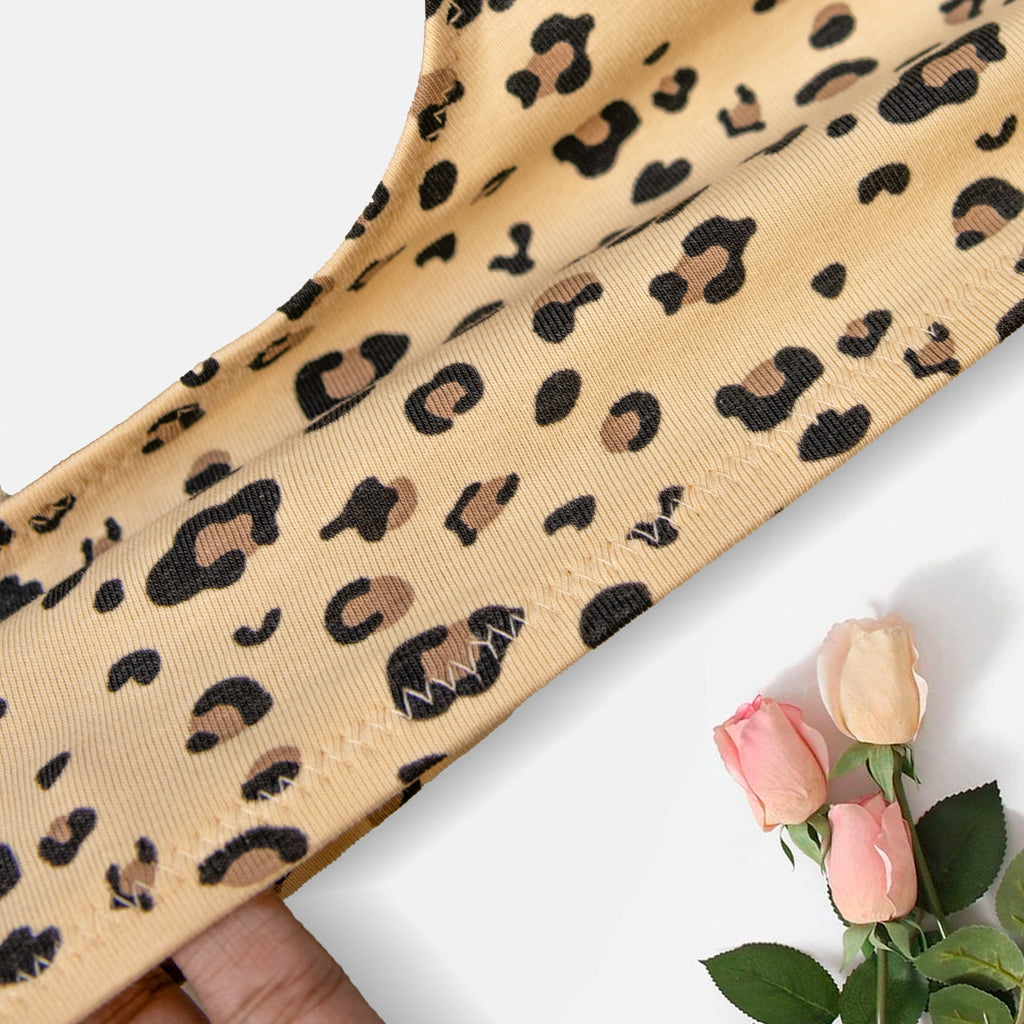 Charmella Hipster Panty fabric with a hand holding it.
