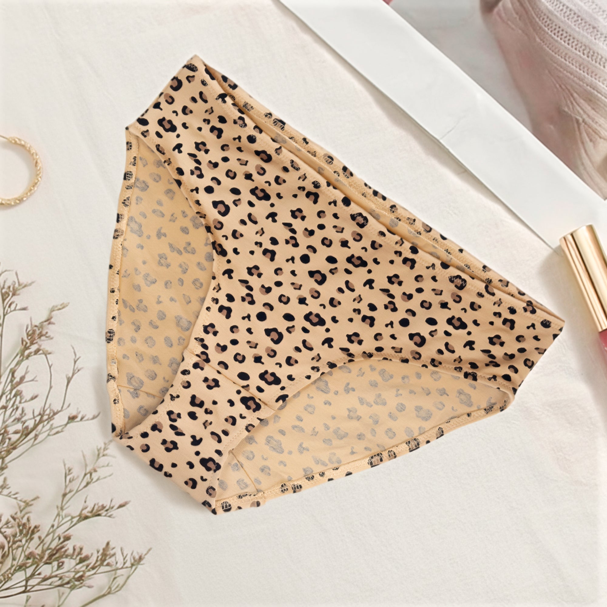 Folded leopard print Charmella Hipster Panty on a light surface.