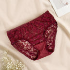Red lace underwear on a beige surface