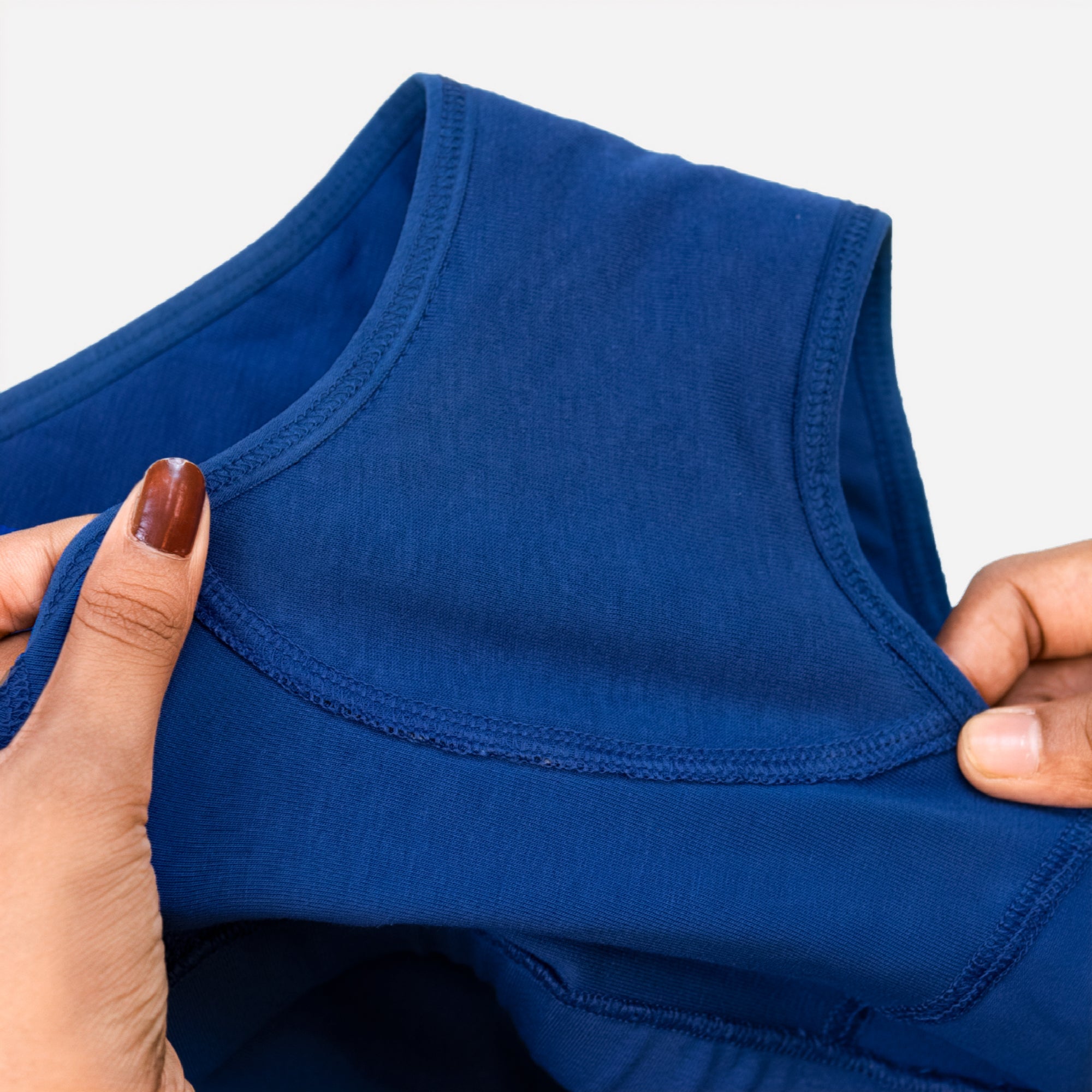 Close-up of a Charmella Blue Period Panty held by hands