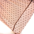 Pink pj set's fabric with black polka dots on a white background