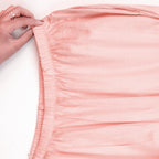 Close-up of a pj set fabric with a hand adjusting it