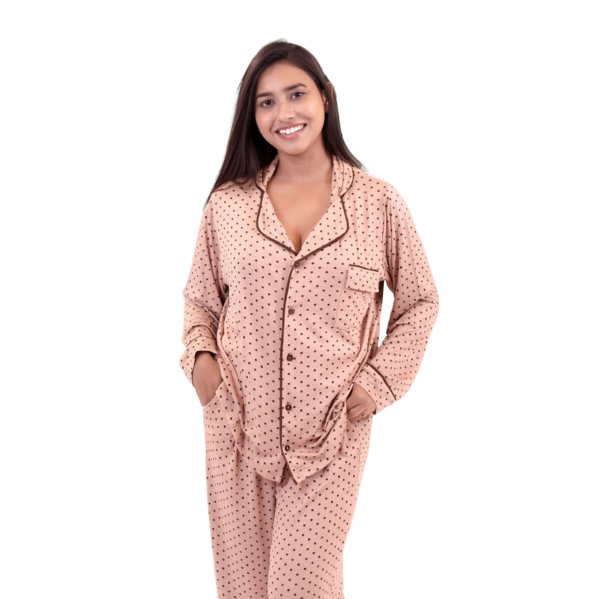 Woman wearing a pink polka dot pj set on a white background