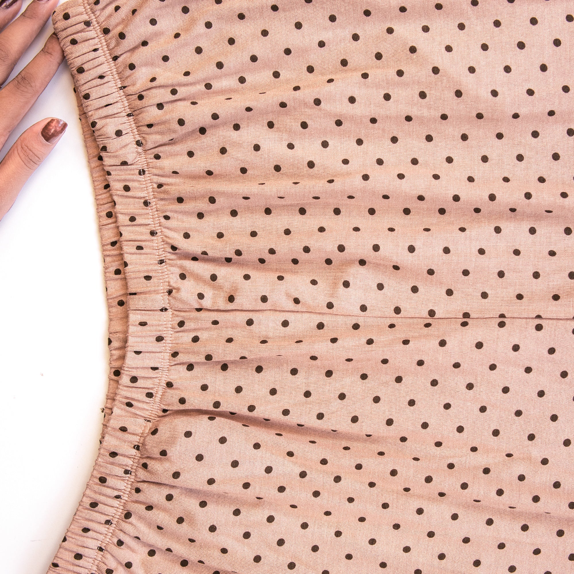 Close-up of pj set fabric with black polka dots