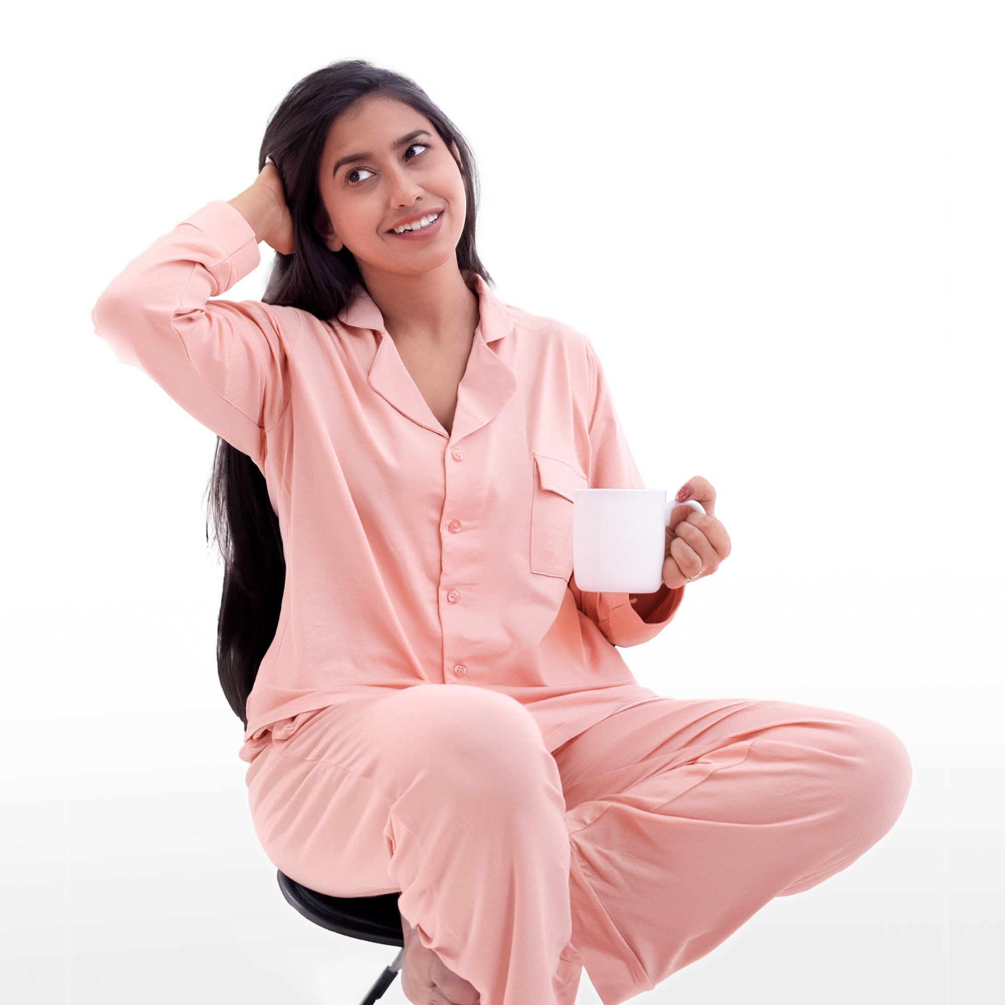Woman in pink pj set & pajamas holding a white mug