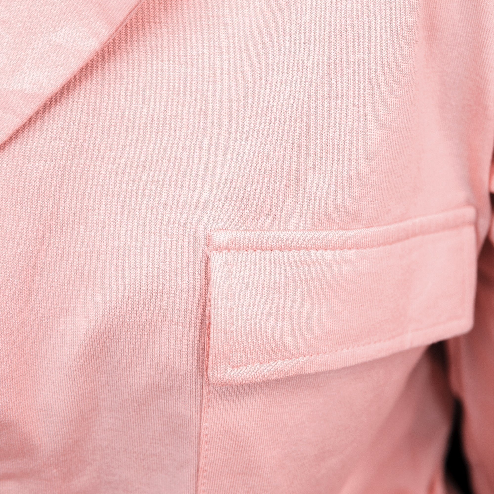 Close-up of a pink pj set's pocket on a garment