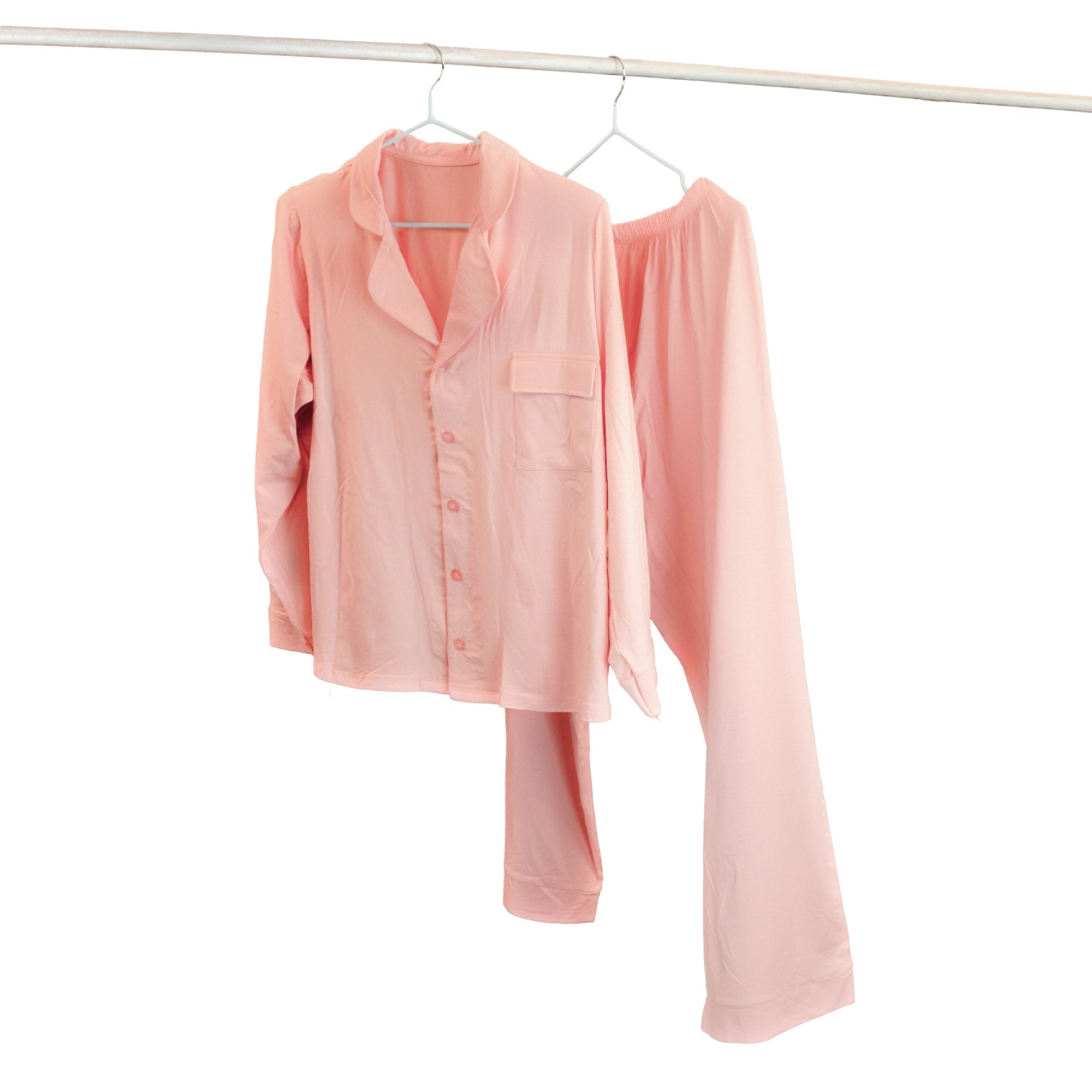 Pink pj set & pajama set hanging on a white background