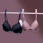 Charmella T-Shirt Bras hanging on a rack against a purple background