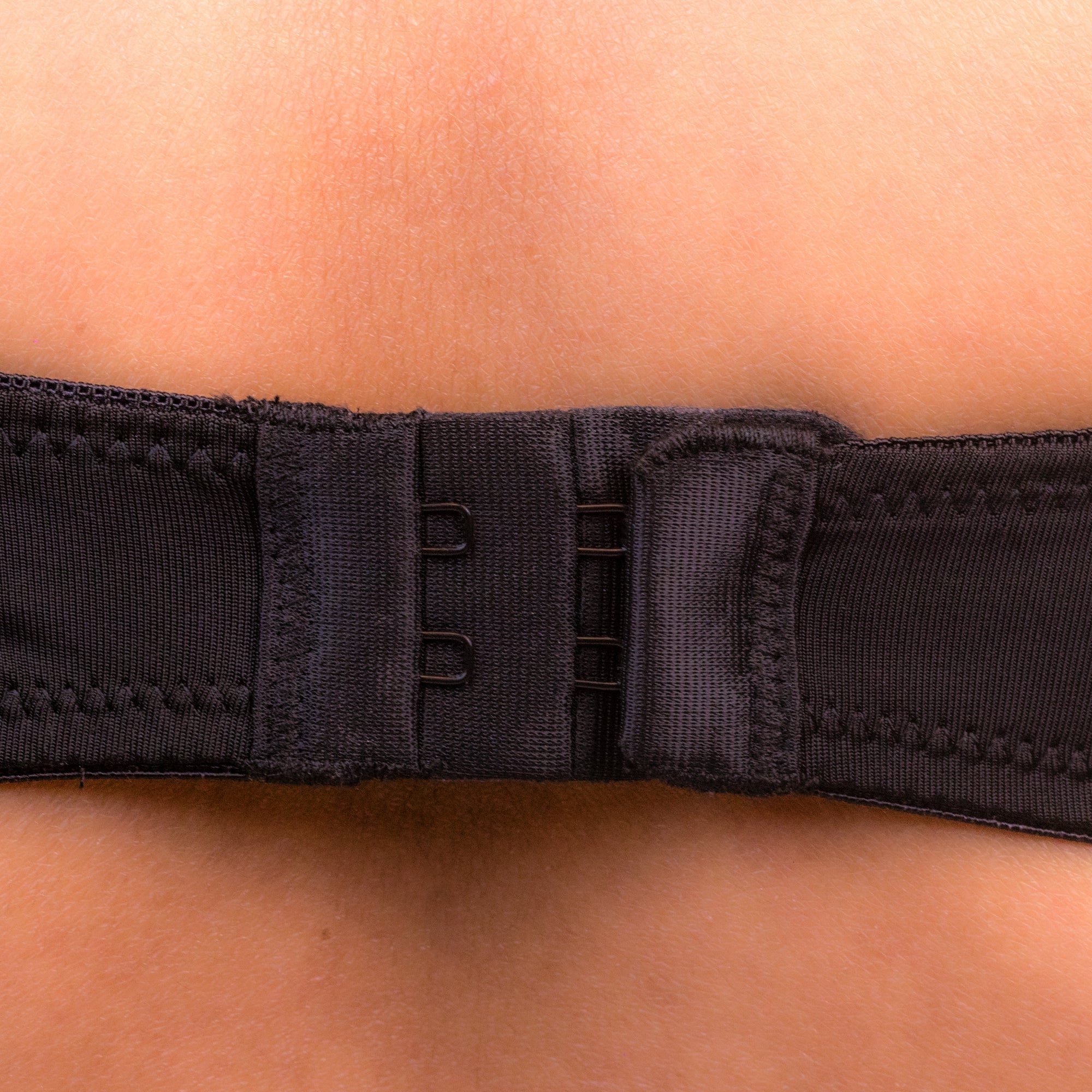 Close-up of a Charmella T-Shirt Bra belt being worn on a person's waist.