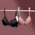 Black and pink Charmella T-Shirt Bras hanging on a rack.