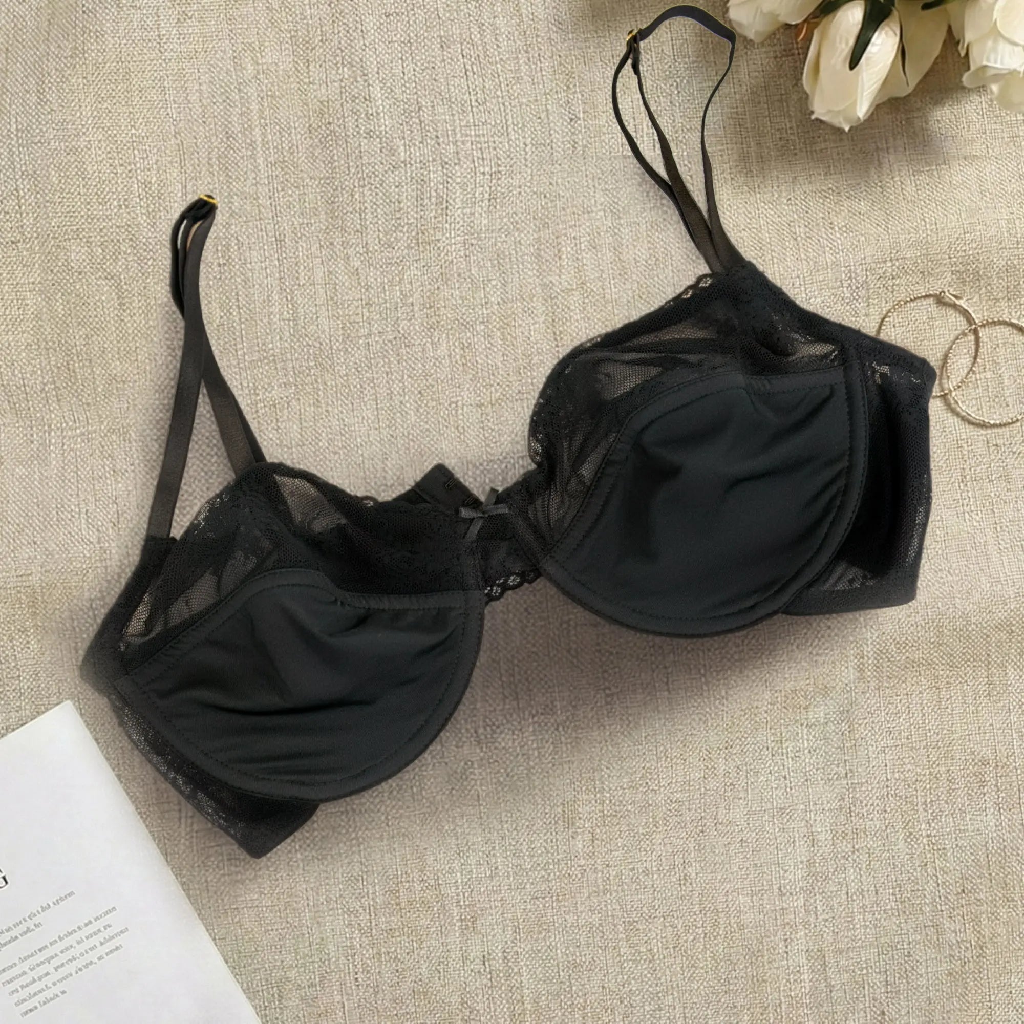 Black bra on a textured surface with flowers